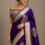 Crafted with premium silk fabric and detailed golden zari work, this royal purple saree is perfect for weddings, festivals, and festive celebrations.