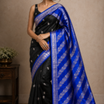 Crafted with premium silk fabric and detailed silver zari work, this black and blue saree is perfect for weddings, festivals, and special occasions.